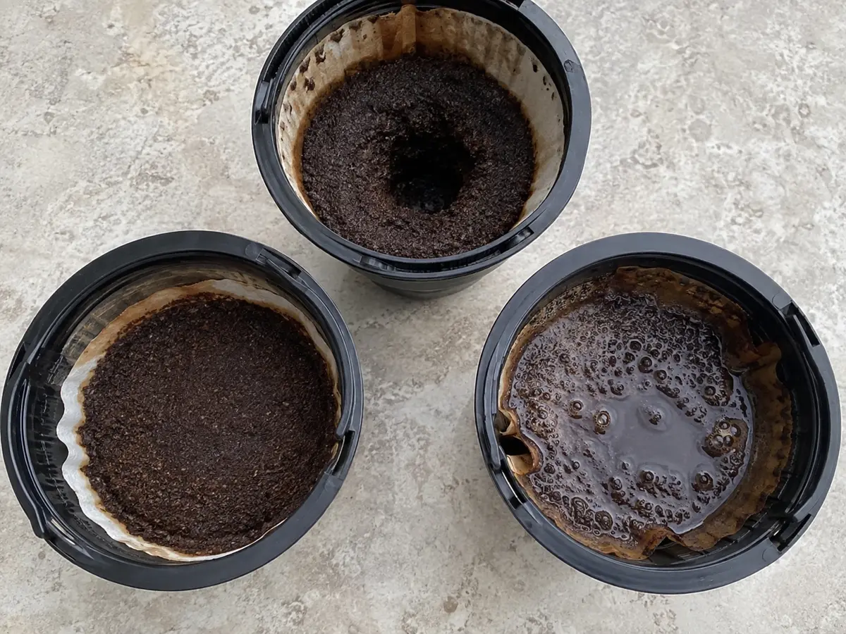 Three spent drip coffee beds showing even drainage, a central crater, and a muddy stalled surface
