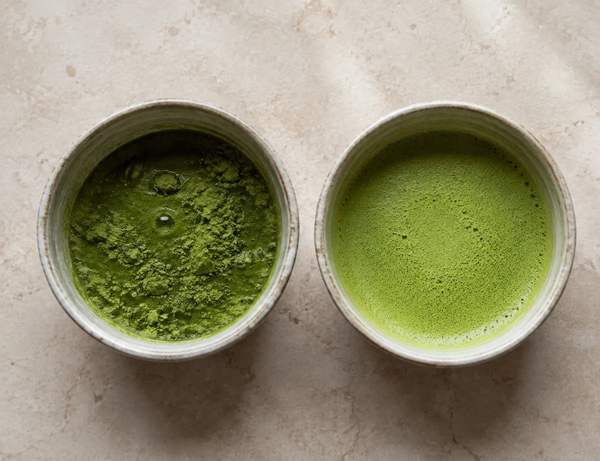 A bowl of poorly whisked matcha with visible clumps beside a smooth foamy bowl