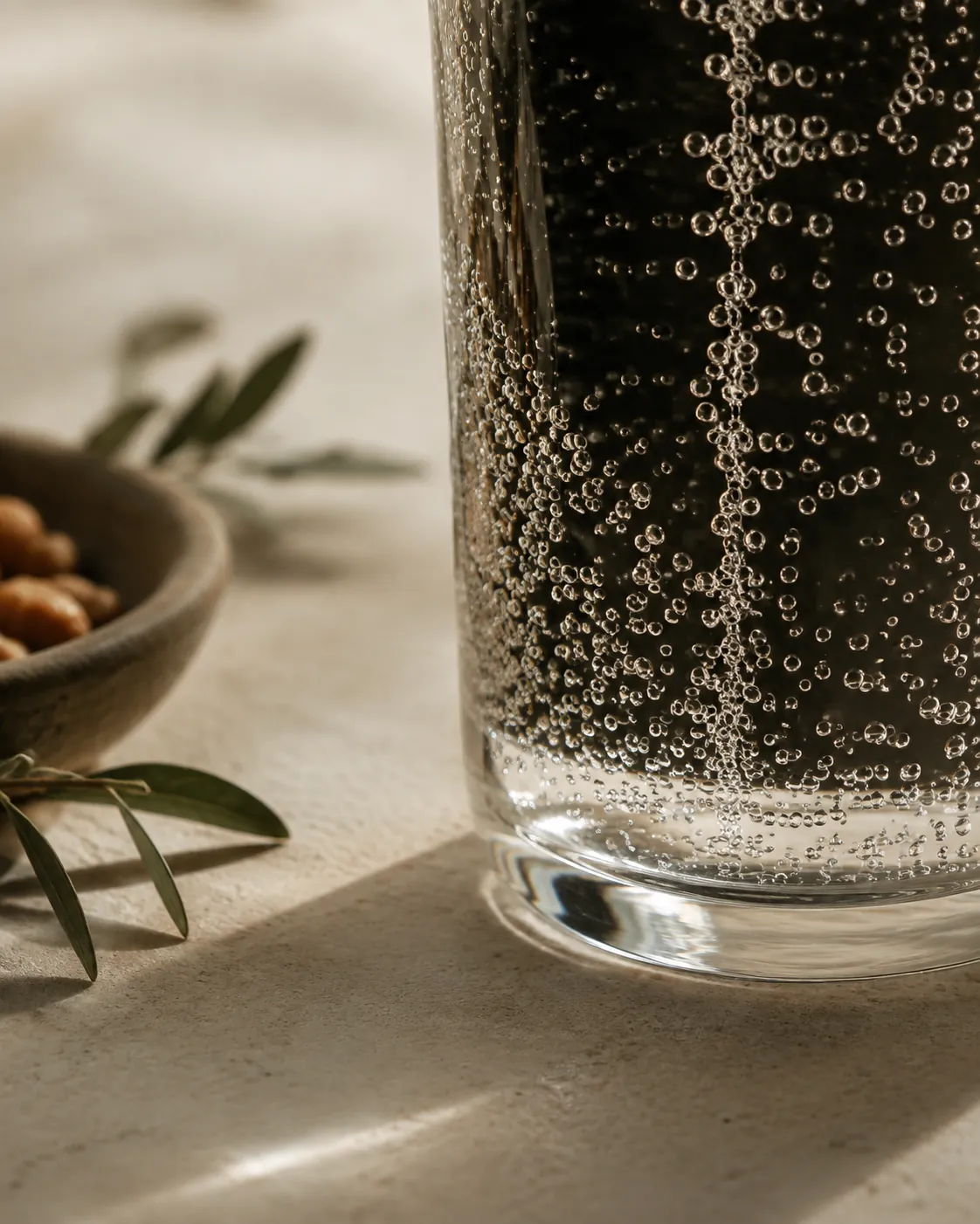 Extreme close view of bubbles clinging to the inside of a glass and rising in a column