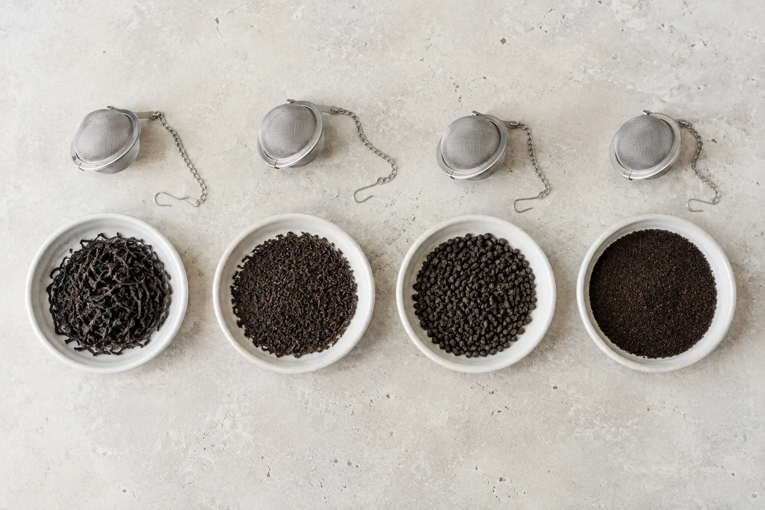 Whole, broken, CTC, and fine black tea leaf forms arranged in separate dishes